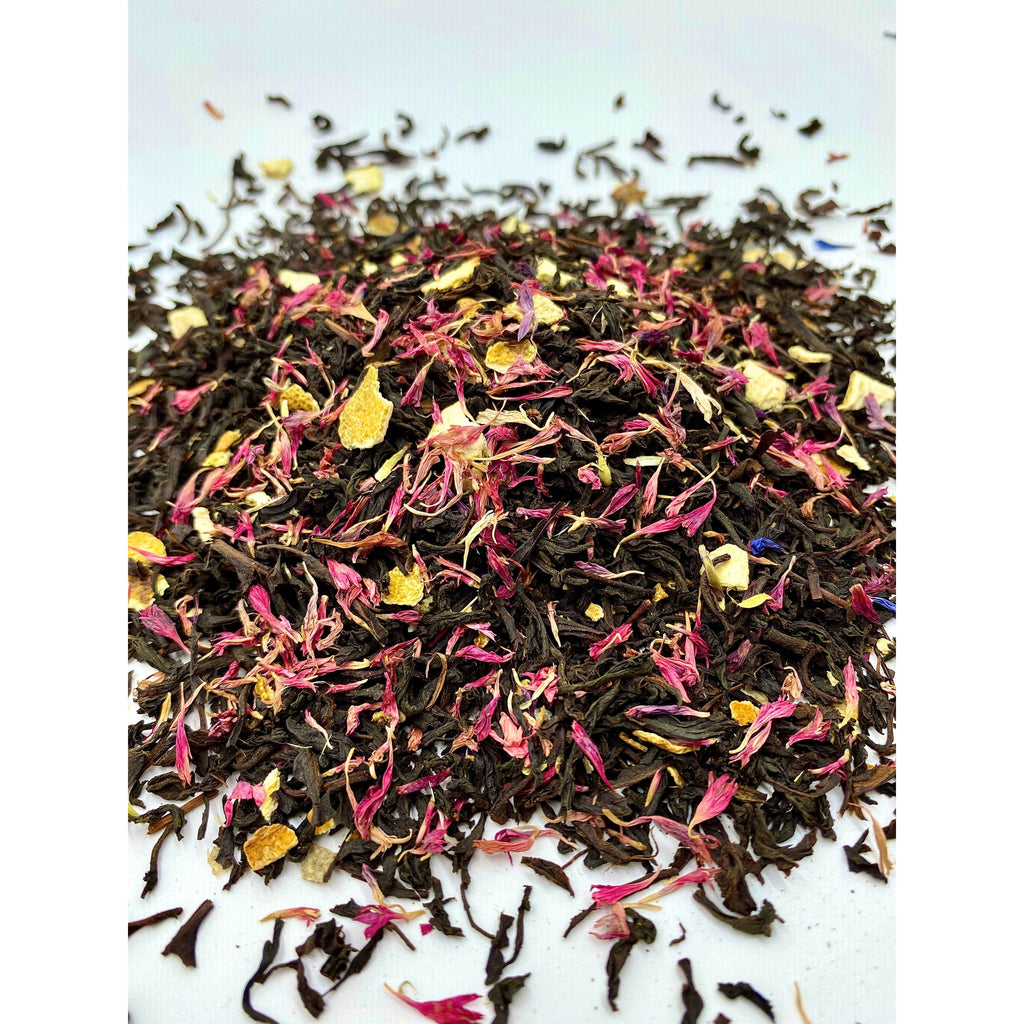 An alternate angle of Leura Countess Grey Tea leaves are scattered to show the cut of the tea and to define the beautiful ingredients within. All crafted for delicious flavours by Blue Mountains Tea Co.