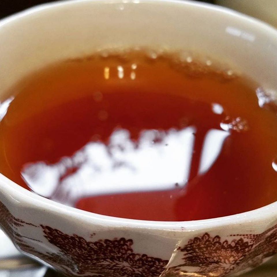 Australian Premium Black - Blue Mountains Tea Co, close up of a light tea infusion in a beautiful Antique cup.